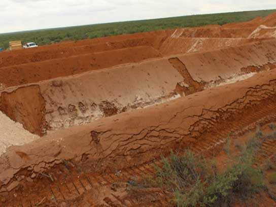 Large dirt pit with large trenches.